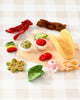 US stockist of Tara Treasures. Felt taco set with toppings on a wooden board against a checkered background