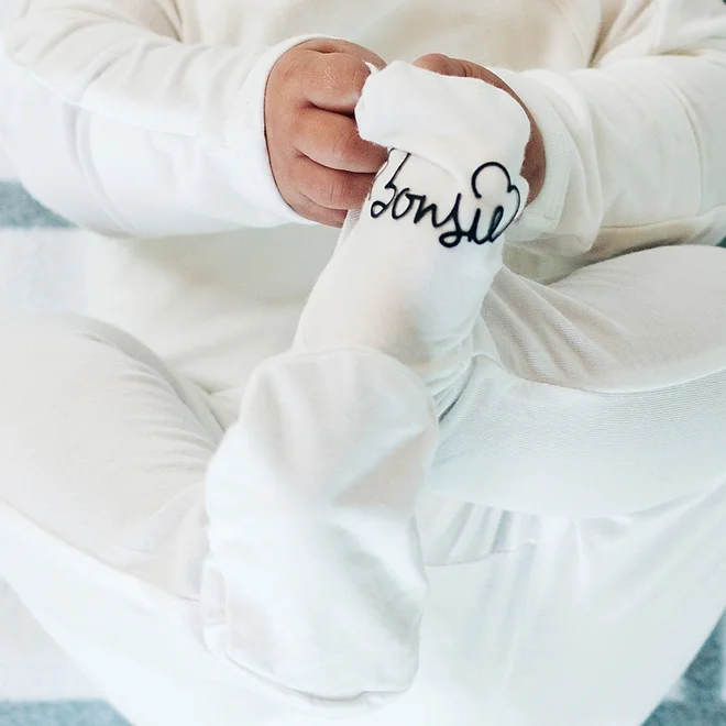 Stockist of Bonsie's rayon blend milk footie.  Top section has velcro wrap body which can be undone for skin to skin contact.  Elastic waist that can be pulled down for easy diaper changes. 