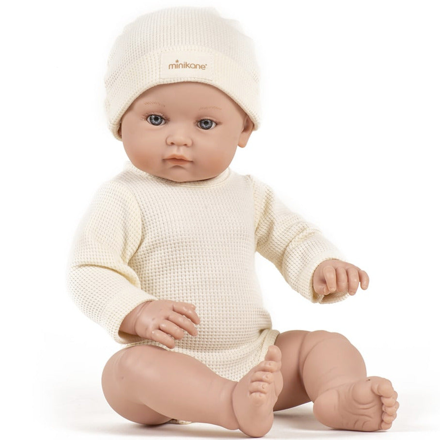 US stockist of Minikane's Bambini Andrea long sleeve bodysuit with matching hat in Ecru