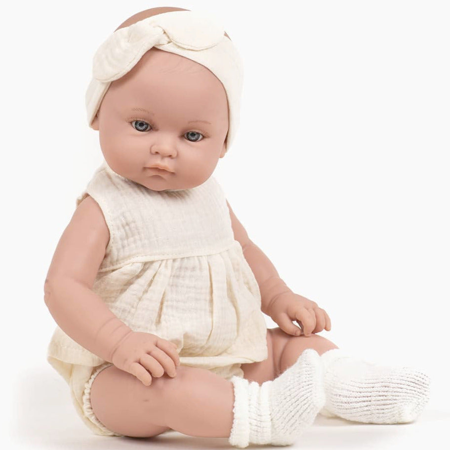 US stockist of Minikane's Yaelle Bambini Girl doll in her Ecru Charlotte set with matching headband.