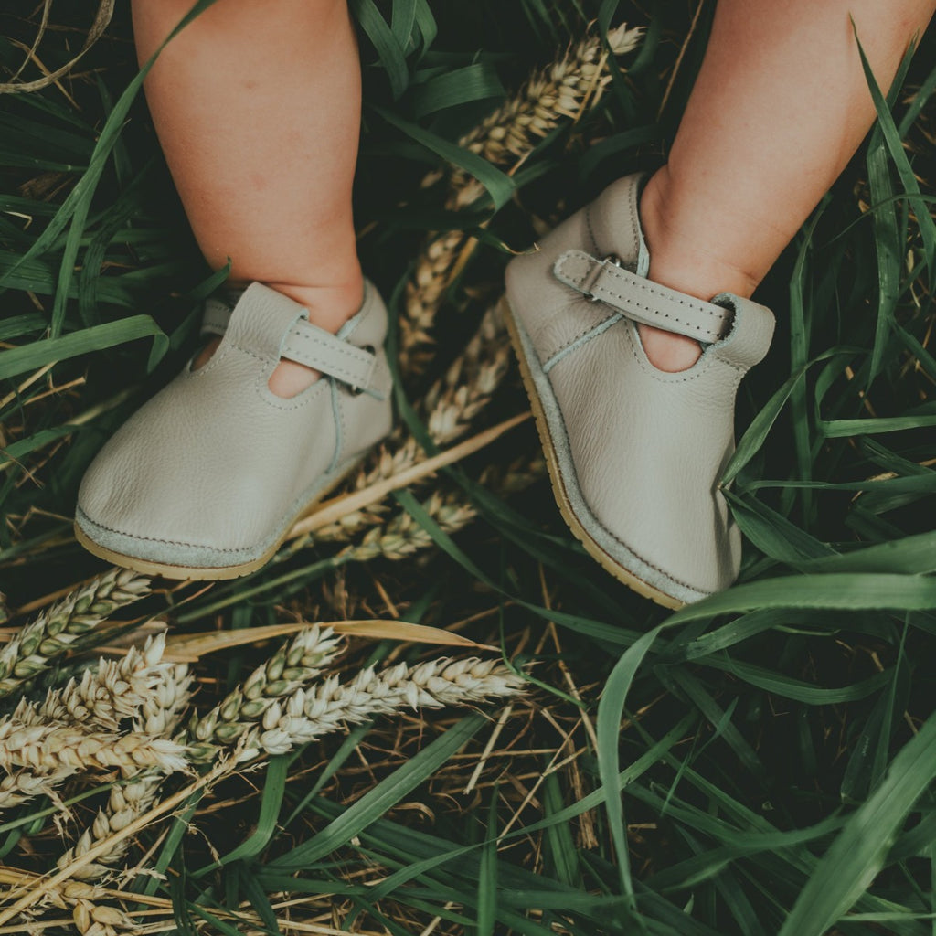 US stockist of Donsje USA's Elia premium handmade leather t-bar shoes.  Light stone in color with velcro fastening.  Sizes 0-12 mths have soft sole, 12-30mths have a soft flexible, rubber sole.