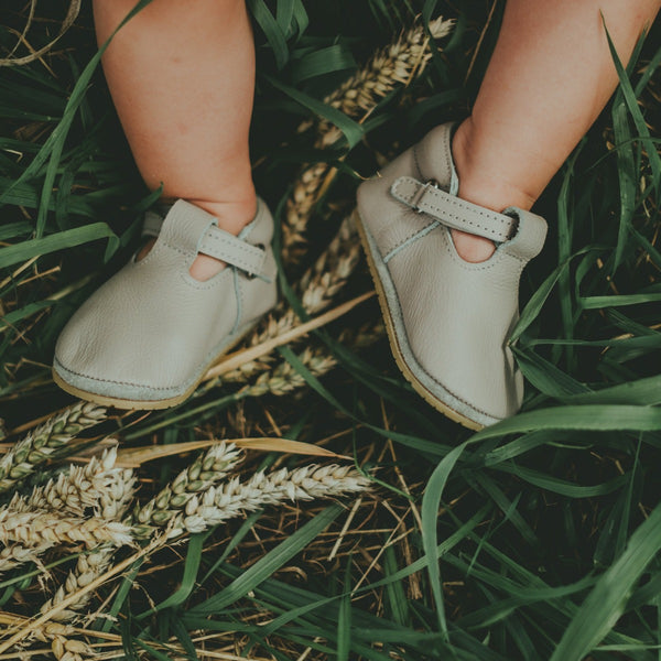 US stockist of Donsje USA's Elia premium handmade leather t-bar shoes.  Light stone in color with velcro fastening.  Sizes 0-12 mths have soft sole, 12-30mths have a soft flexible, rubber sole.