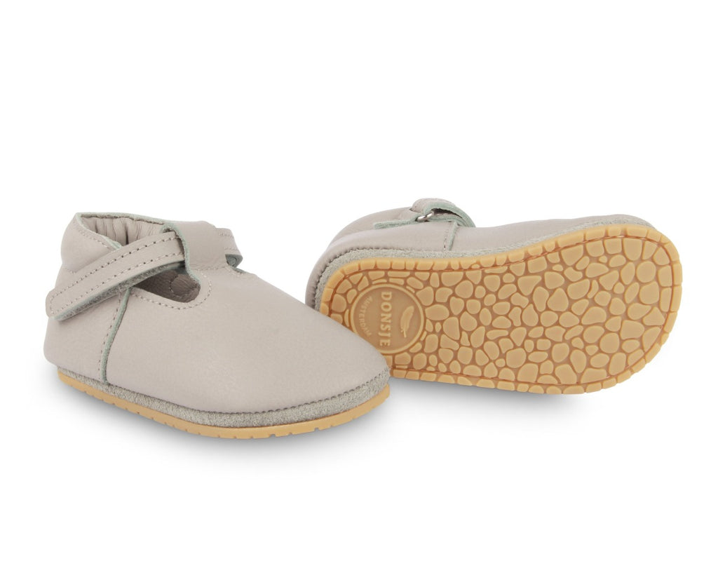 US stockist of Donsje USA's Elia premium handmade leather t-bar shoes.  Light stone in color with velcro fastening.  Sizes 0-12 mths have soft sole, 12-30mths have a soft flexible, rubber sole.