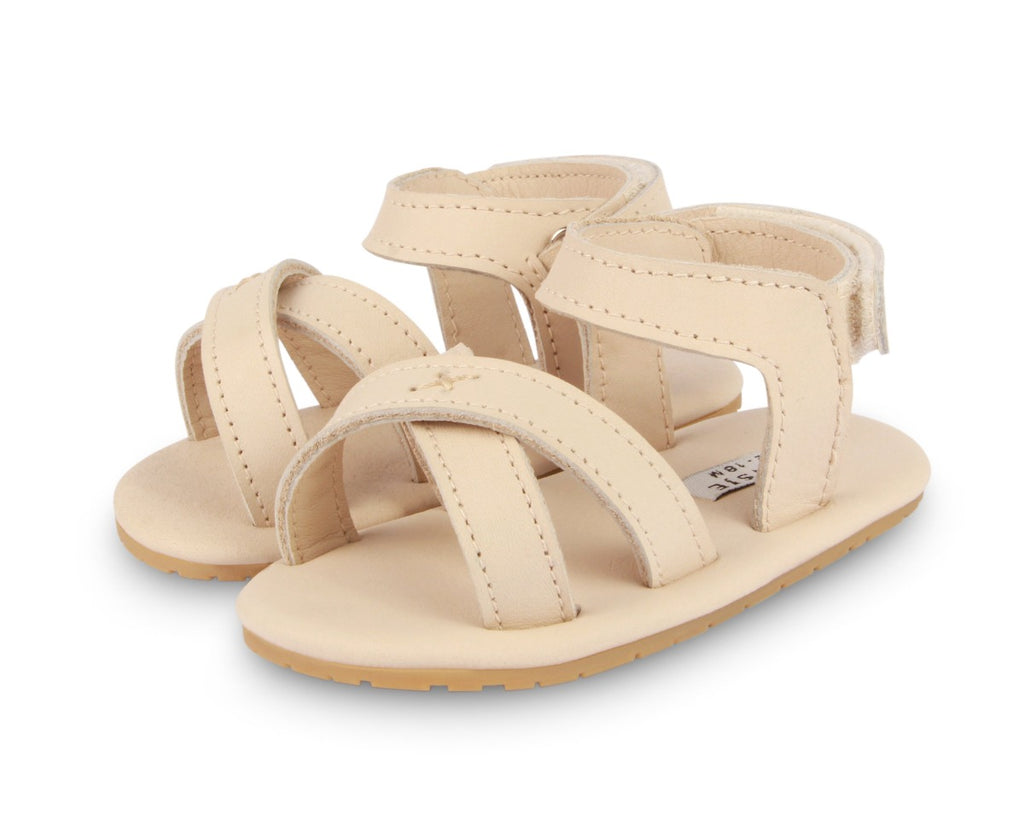 US stockist of Donsje USA's Giggles premium handmade leather sandals.  Cream in color with velcro fastening at back.  Sizes 0-12 mths have soft sole, 12-30mths have a soft flexible, rubber sole.