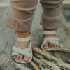 US stockist of Donsje USA's Giggles premium handmade leather sandals.  Cream in color with velcro fastening at back.  Sizes 0-12 mths have soft sole, 12-30mths have a soft flexible, rubber sole.
