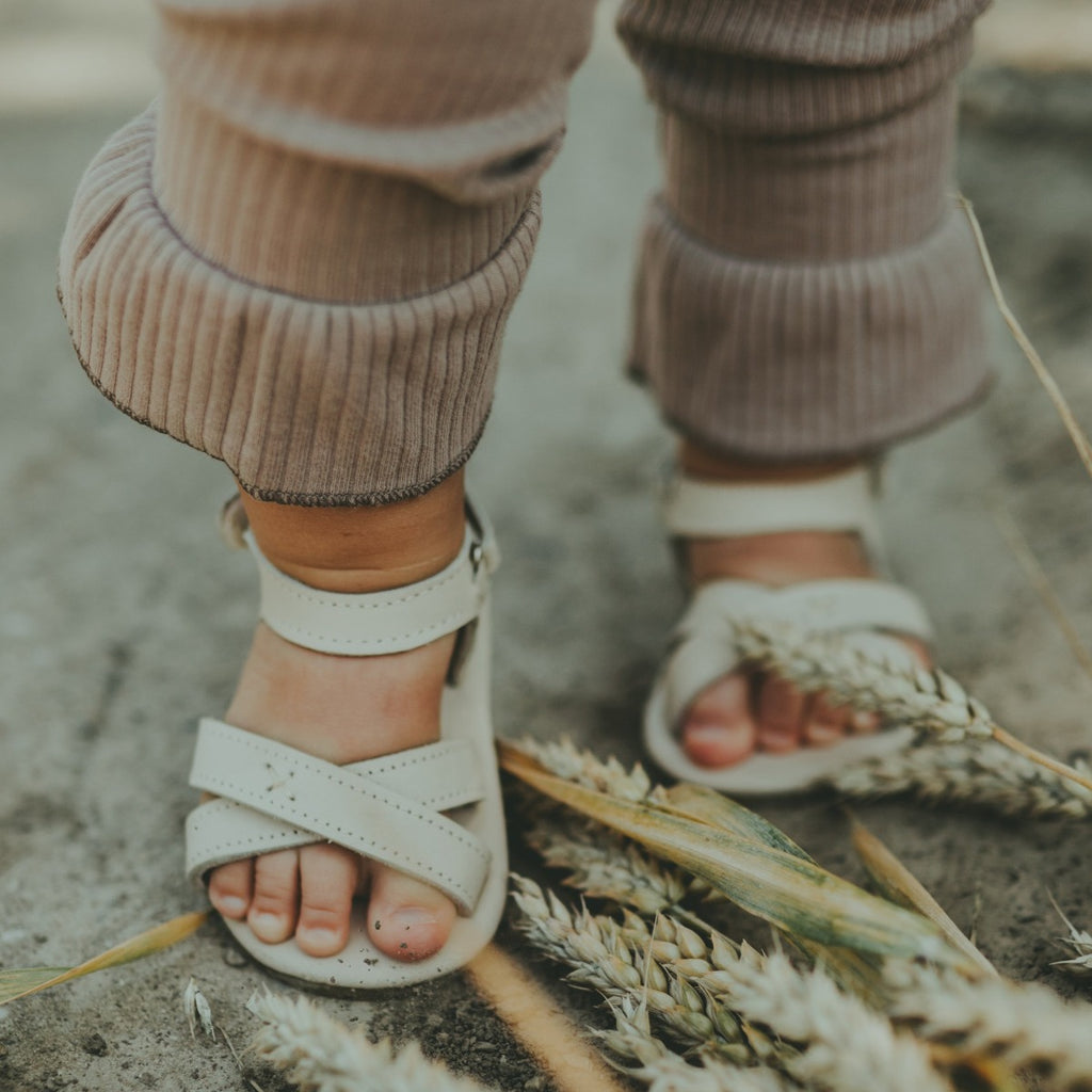 US stockist of Donsje USA's Giggles premium handmade leather sandals.  Cream in color with velcro fastening at back.  Sizes 0-12 mths have soft sole, 12-30mths have a soft flexible, rubber sole.