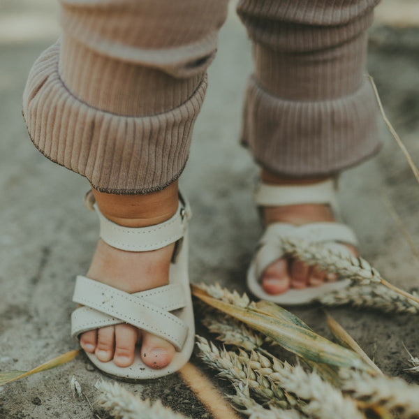 US stockist of Donsje USA's Giggles premium handmade leather sandals.  Cream in color with velcro fastening at back.  Sizes 0-12 mths have soft sole, 12-30mths have a soft flexible, rubber sole.