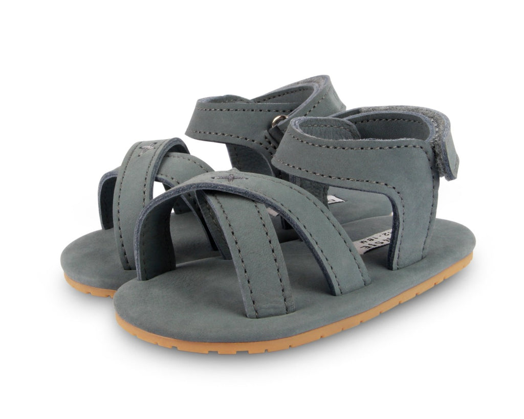 US stockist of Donsje USA's Giggles premium handmade leather nubuck sandals.  Petrol Grey in color with velcro fastening at back.  Sizes 0-12 mths have soft sole, 12-30mths have a soft flexible, rubber sole.
