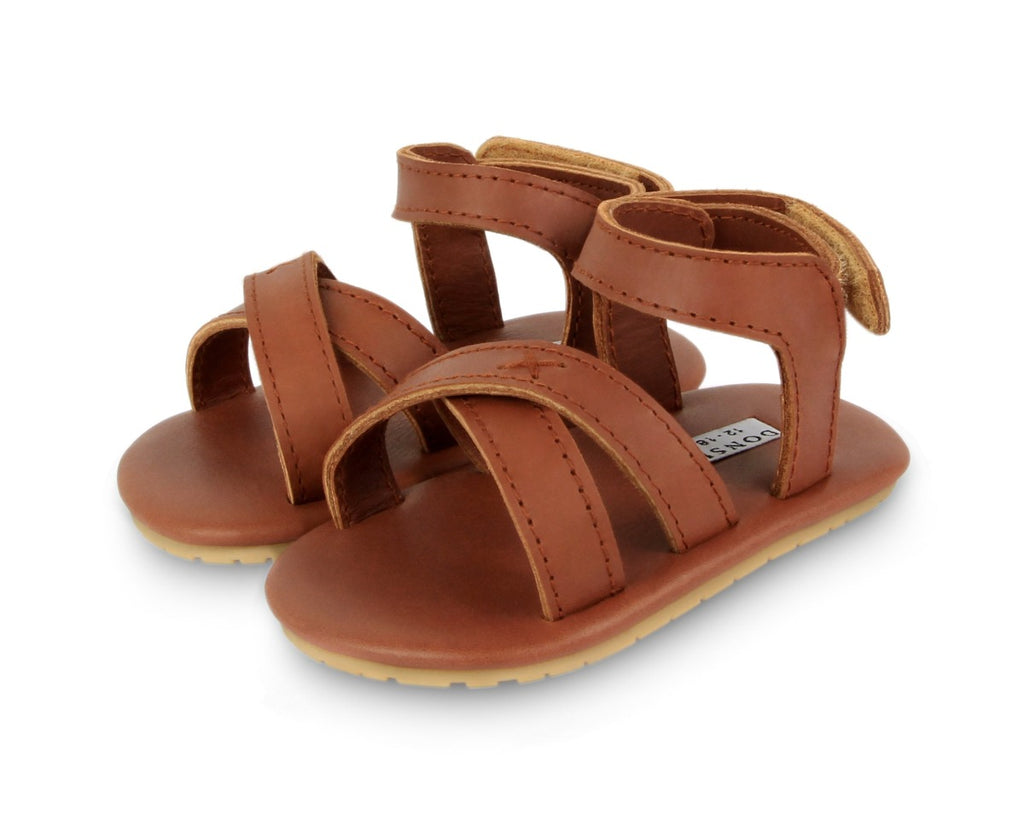 US stockist of Donsje USA's Giggles premium handmade leather sandals.  Cream in color with velcro fastening at back.  Sizes 0-12 mths have soft sole, 12-30mths have a soft flexible, rubber sole.