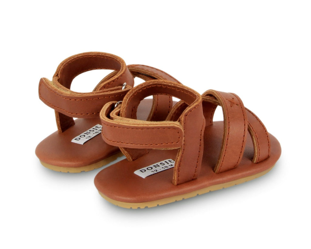 US stockist of Donsje USA's Giggles premium handmade leather sandals.  Cream in color with velcro fastening at back.  Sizes 0-12 mths have soft sole, 12-30mths have a soft flexible, rubber sole.