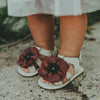 US stockist of Donsje USA's Poppy Tuti Fields premium handmade leather sandals.  Cream in color with beautiful red poppy on front and velcro fastening at back.  Sizes 0-12 mths have soft sole, 12-30mths have a soft flexible, rubber sole.