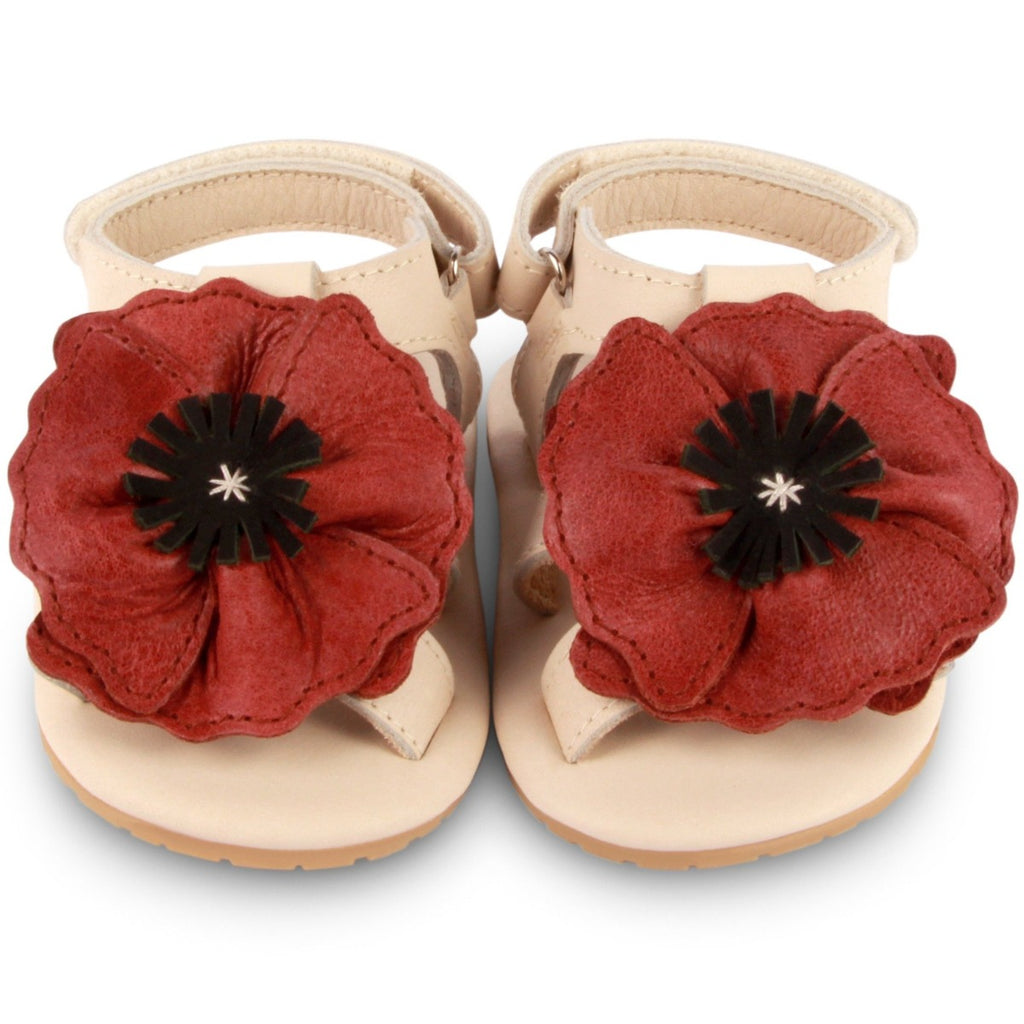 US stockist of Donsje USA's Poppy Tuti Fields premium handmade leather sandals.  Cream in color with beautiful red poppy on front and velcro fastening at back.  Sizes 0-12 mths have soft sole, 12-30mths have a soft flexible, rubber sole.