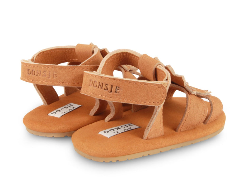 US stockist of Donsje USA's Poppy Tuti Fields premium handmade leather sandals.  Tan in color with a lovely tan sunflower on front and velcro fastening at back.  Sizes 0-12 mths have soft sole, 12-30mths have a soft flexible, rubber sole.
