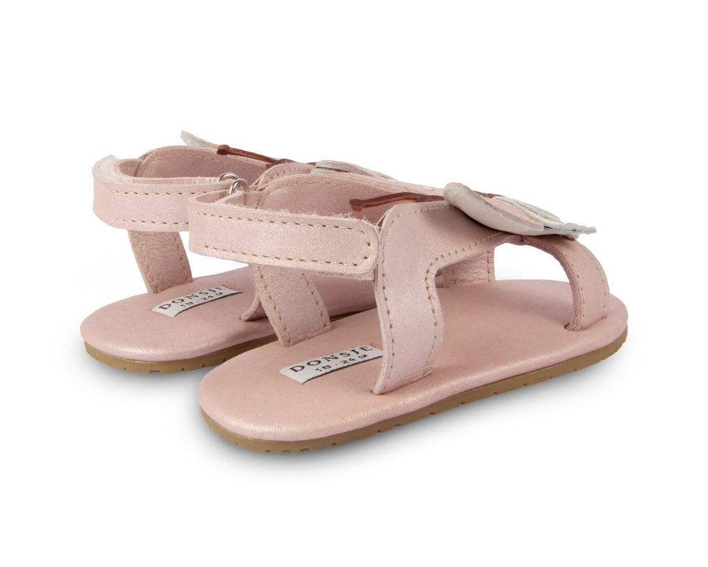 US stockist of Donsje USA's Butterfly Tuti Sky  premium handmade leather sandals.  Pink in color with beautiful cream/pink butterfly on front and velcro fastening at back.  Sizes 0-12 mths have soft sole, 12-30mths have a soft flexible, rubber sole.