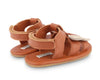 US stockist of Donsje USA's Honey Bee Tuti Sky  premium handmade leather sandals.  Tan in color with beautiful tan/cream honey bee on front and velcro fastening at back.  Sizes 0-12 mths have soft sole, 12-30mths have a soft flexible, rubber sole.