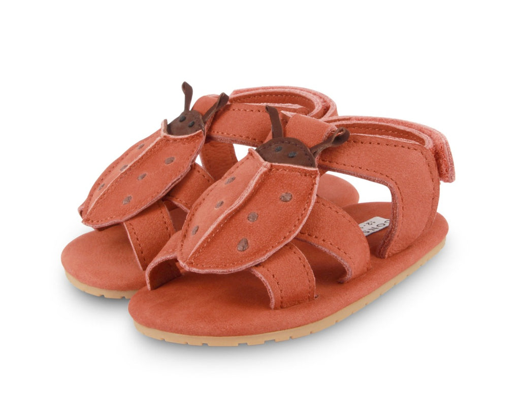 US stockist of Donsje USA's Lady Bird Tuti Sky  premium handmade leather sandals.  Red in color with beautiful lady bird on front and velcro fastening at back.  Sizes 0-12 mths have soft sole, 12-30mths have a soft flexible, rubber sole.