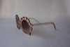 US stockist of Elle Porte's Shelly sunglasses in peach.  Shell shaped frames with brown UV 400 lenses.