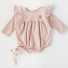 US stockist of Karibou Kid's Milana Winged Playsuit in soft pink.  Made from soft cotton, featuring long sleeves and ruffled wings at shoulders.