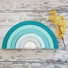 US stockist of Children of the Trees handmade 6pc rainbow stacker wooden toy in shades of aqua blue.