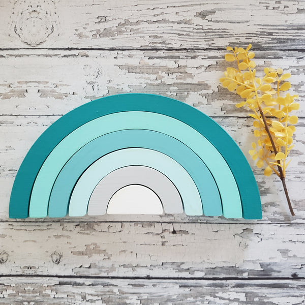 US stockist of Children of the Trees handmade 6pc rainbow stacker wooden toy in shades of aqua blue.