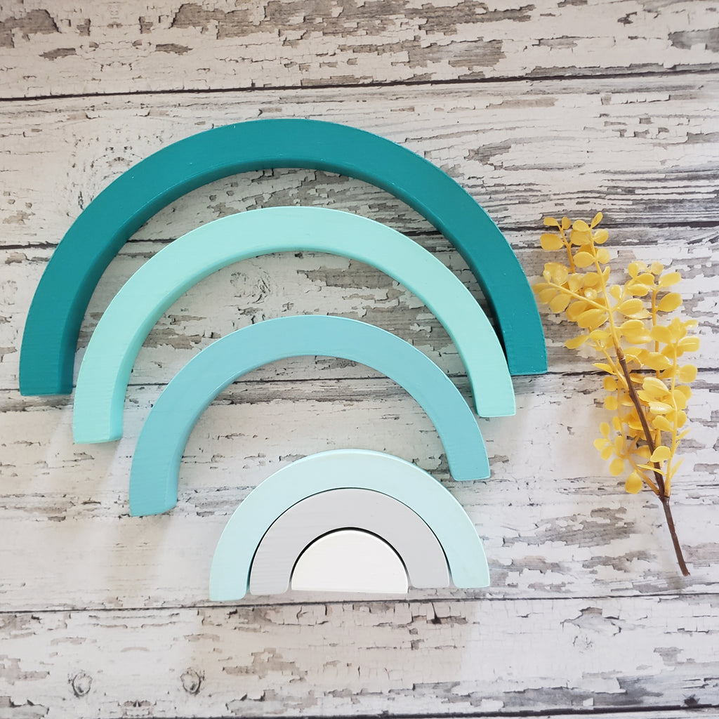 US stockist of Children of the Trees handmade 6pc rainbow stacker wooden toy in shades of aqua blue.