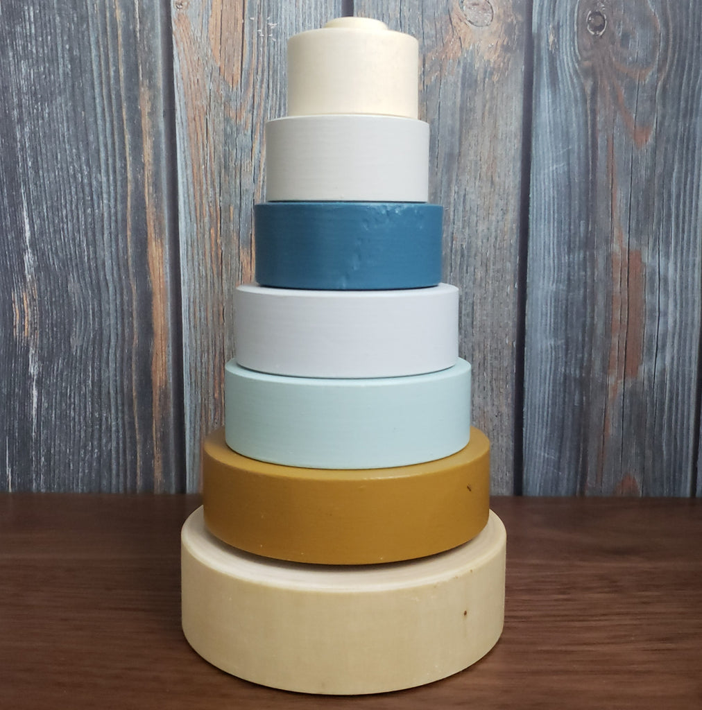 US stockist of Children of the Trees hand painted ring stacker wooden toy in blues and with a striking gold ring