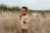 US stockist of Grown Clothing's gender neutral chunky knit rib bloomers in tan. Made from 100% cotton with an elastic waistband and two mock wooden buttons.
