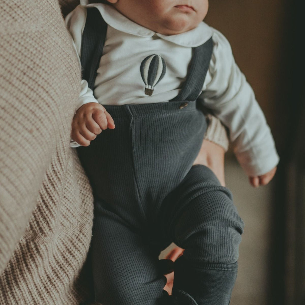 US stockist of Donsje's gender neutral, Dena ribbed suspender leggings in Dark Spruce