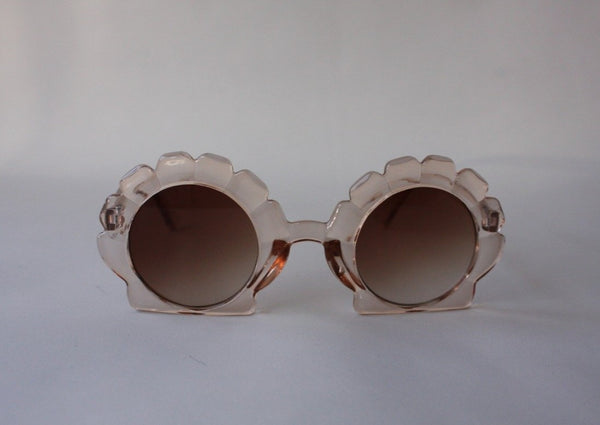 US stockist of Elle Porte's Shelly sunglasses in peach.  Shell shaped frames with brown UV 400 lenses.