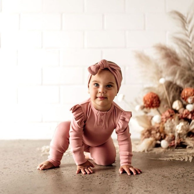 US stockist of Snuggle Hunny Kid's organic cotton jersey, rose ruffle zip footed sleeper.