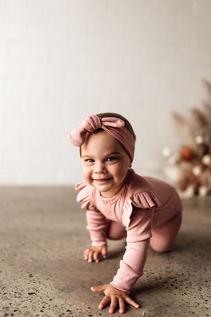 US stockist of Snuggle Hunny Kid's organic cotton jersey, rose ruffle zip footed sleeper.