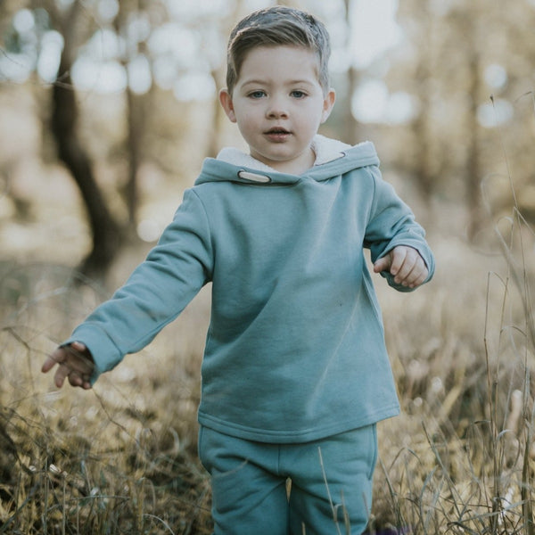 US stockist of Five O' Six's organic cotton, gender neutral hooded sweatshirt in Slate.  Features sherpa lined hooded for added warmth and comfort.