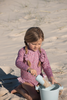 US stockist of Salty Swimwear's Zoe long sleeve rashsuit in candy wildflowers.  Made from pink UPF 50+ recycled Repreve fabric with pretty wildflower print. Fully lined, with invisible back zipper and signature Salty frill on legs.