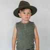 US stockist of Buck & Baa's organic dappled henley tank top.  Made from organic cotton and elastane in a blue/green color with all over spotted print. Coconut buttons on front placket.