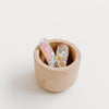 US stockist of Josie Joan's Little Poppy fabric hair clips.  Set of two fabric baby hair clips made from pale coloured fabric with blue and pink flowers and  contrasting tan leaves.  Has scalloped edging.