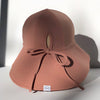 US stockist of Fini the Label's gender neutral, floppy swim hat in cocoa. Features elongated back for added sun protection, chin strap and adjustable bow around crown for better fit. Brim is medium stiffness and can be flipped up at front.  Made from nylon/spandex and is quick drying.