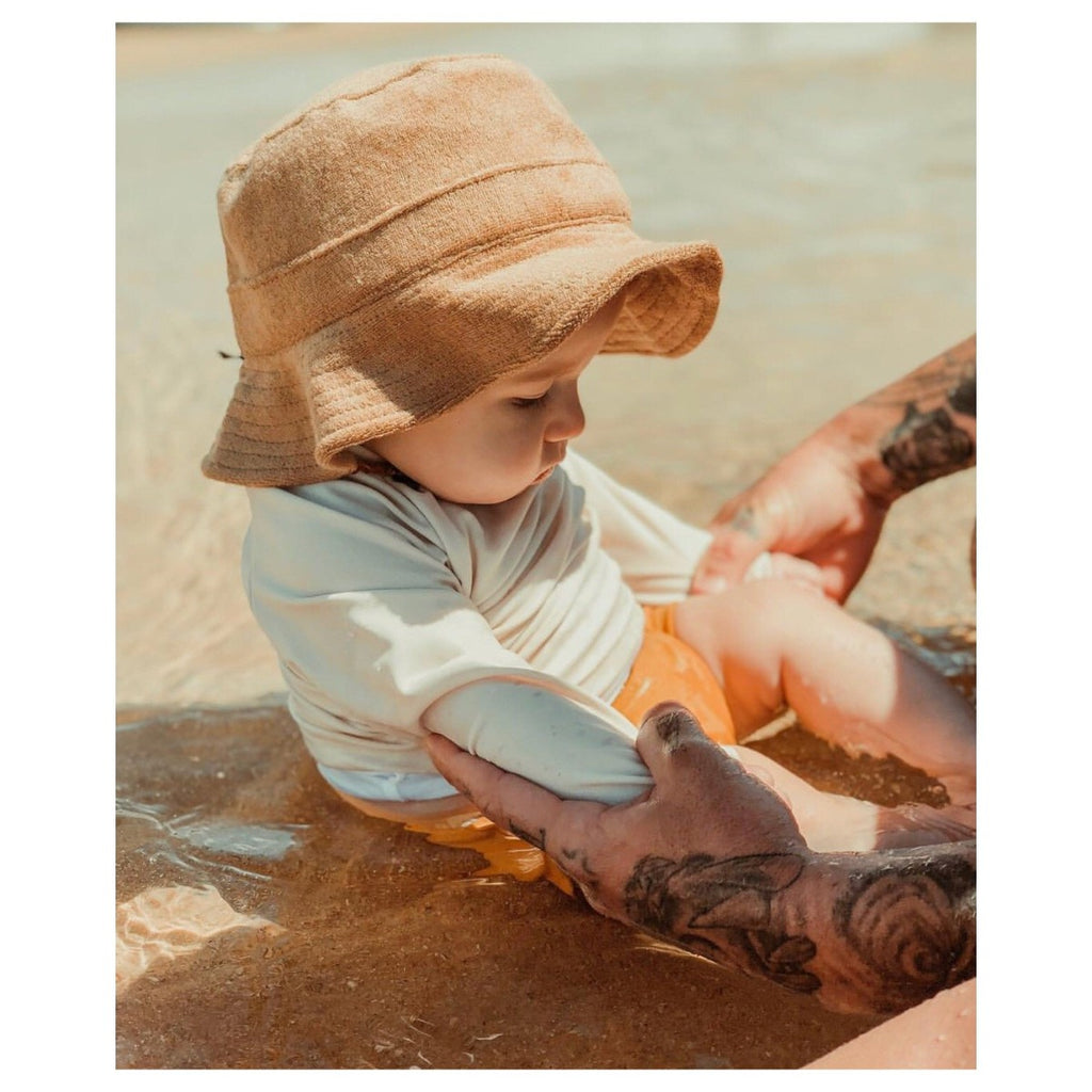 US stockist of Fini the Label's tan bucket hat made from soft terry towelling fabric.