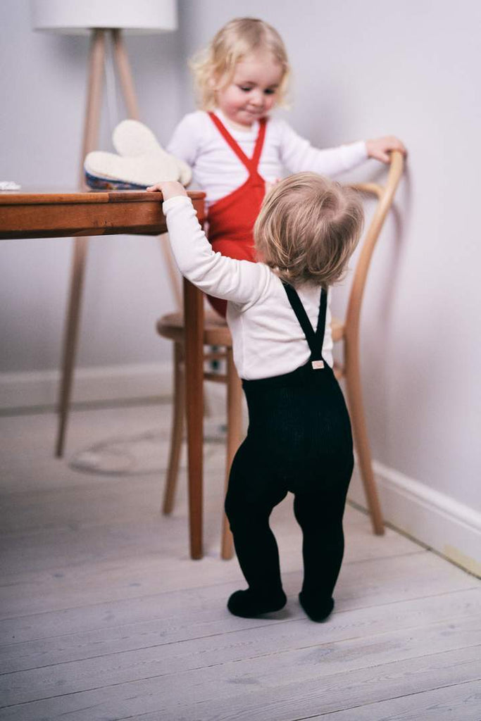 US stockist of Silly Silas gender neutral retro ribbed footed tights in classic black.  Made from 100% cotton and features braces.