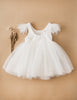 US stockist of Karibou Kids white Angelina Feather and Lace Dress.  Features 5 layer full skirt, lace bodice, scoop back and ostrich feather flutter sleeves. 
