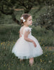 US stockist of Karibou Kids white Angelina Feather and Lace Dress.  Features 5 layer full skirt, lace bodice, scoop back and ostrich feather flutter sleeves. 