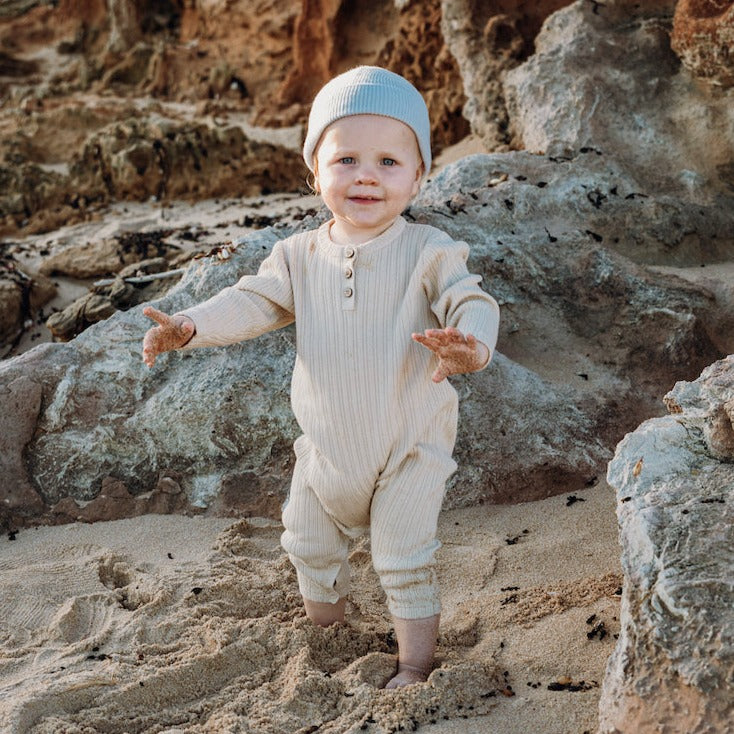 US stockist of Grown Clothing's gender neutral, organic cotton ribbed button jumpsuit in Natural.