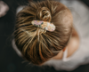 US stockist of Josie Joan's Audrey fabric hair clips.  Set of two fabric hair clips made from pale coloured fabric with bright orange, purple, red, yellow or pink flowers and  contrasting green leaves.  Has scalloped edging.