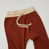US stockist of Bel & Bow's gender neutral ribbed cotton joggers in rust.  Has a contrasing cream cuffs and waistband with functional drawstring.