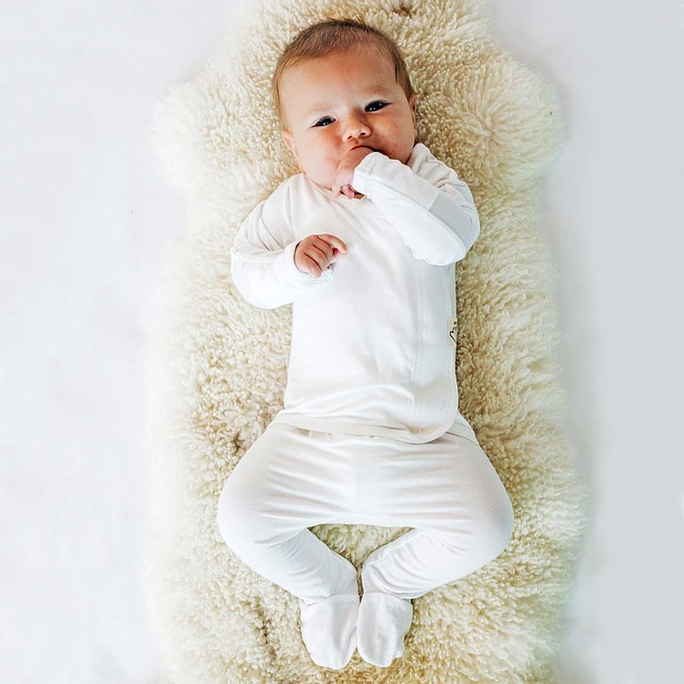 Stockist of Bonsie's rayon blend milk footie.  Top section has velcro wrap body which can be undone for skin to skin contact.  Elastic waist that can be pulled down for easy diaper changes. 