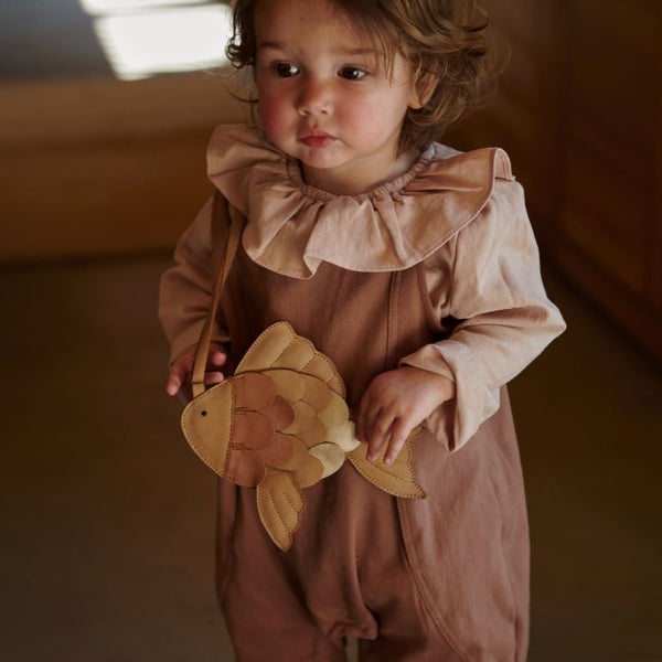 US stockist of Donsje's long sleeve chloe bodysuit in Crystal Pink.  Made from cotton with a ruffle neck.