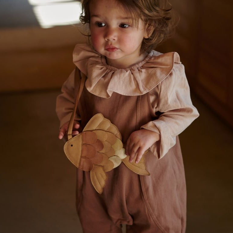 US stockist of Donsje's long sleeve chloe bodysuit in Crystal Pink.  Made from cotton with a ruffle neck.
