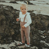 US stockist of Donsje's long sleeve chloe bodysuit in Buttercream.  Made from cotton with a ruffle neck.