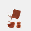 US stockist of Olli Ella's Dinkum Doll Knit Umber Set.  Features cotton knit bonnet and hard sole knit booties with pom poms on front. 