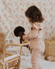 US stockist of India + Grace The Label's dusty pink long sleeved ribbed cotton bodysuit.  Features crotch snaps and beautiful ruffles at shoulder.  