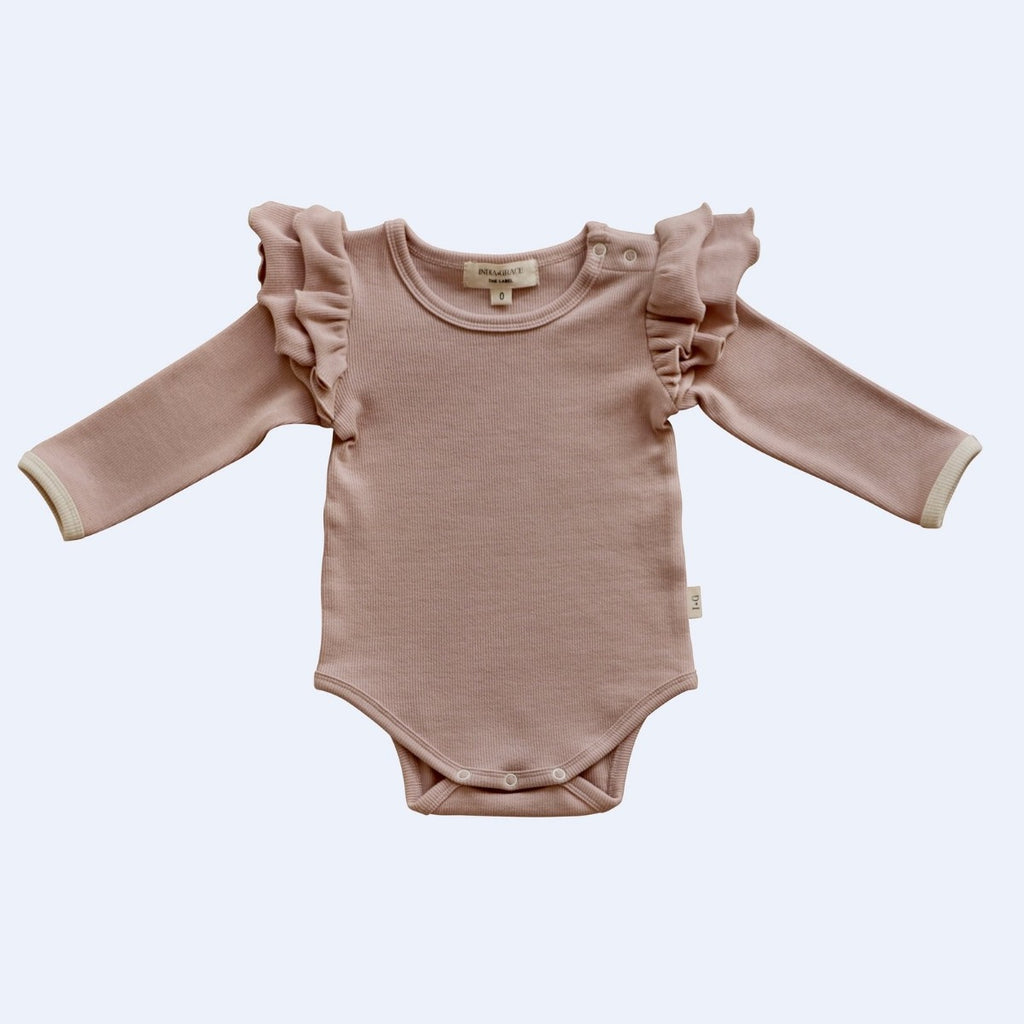 US stockist of India + Grace The Label's dusty pink long sleeved ribbed cotton bodysuit.  Features crotch snaps and beautiful ruffles at shoulder.  
